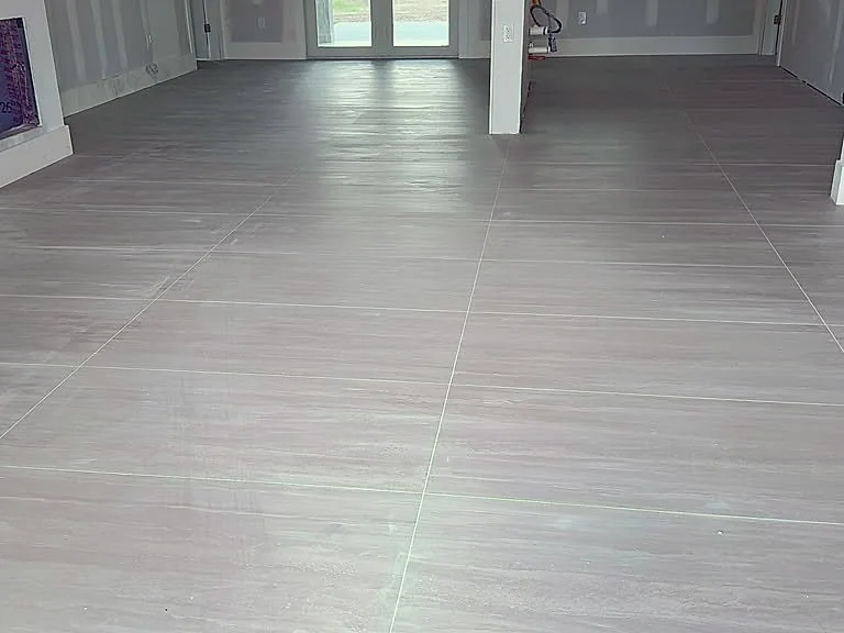 Open floor plan finished with large-format gray plank tile