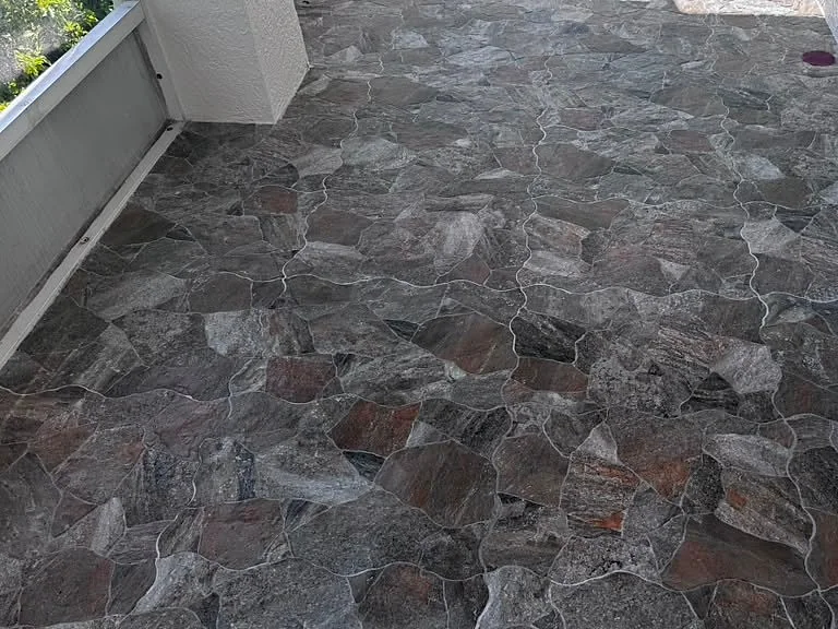 Dark multicolored natural stone floor laid in an irregular pattern